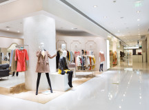 Boutique display window with mannequins in fashionable dresses