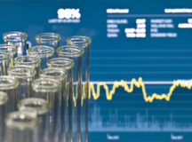 Test tubes over financial data. Concept for Investing in Life Science.