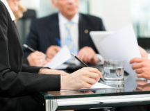 Business - meeting in an office, lawyers or attorneys discussing a document or contract agreement